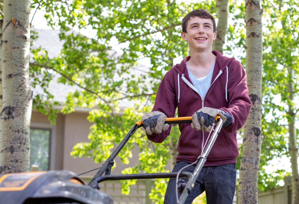 Teenager Mowing Lawn